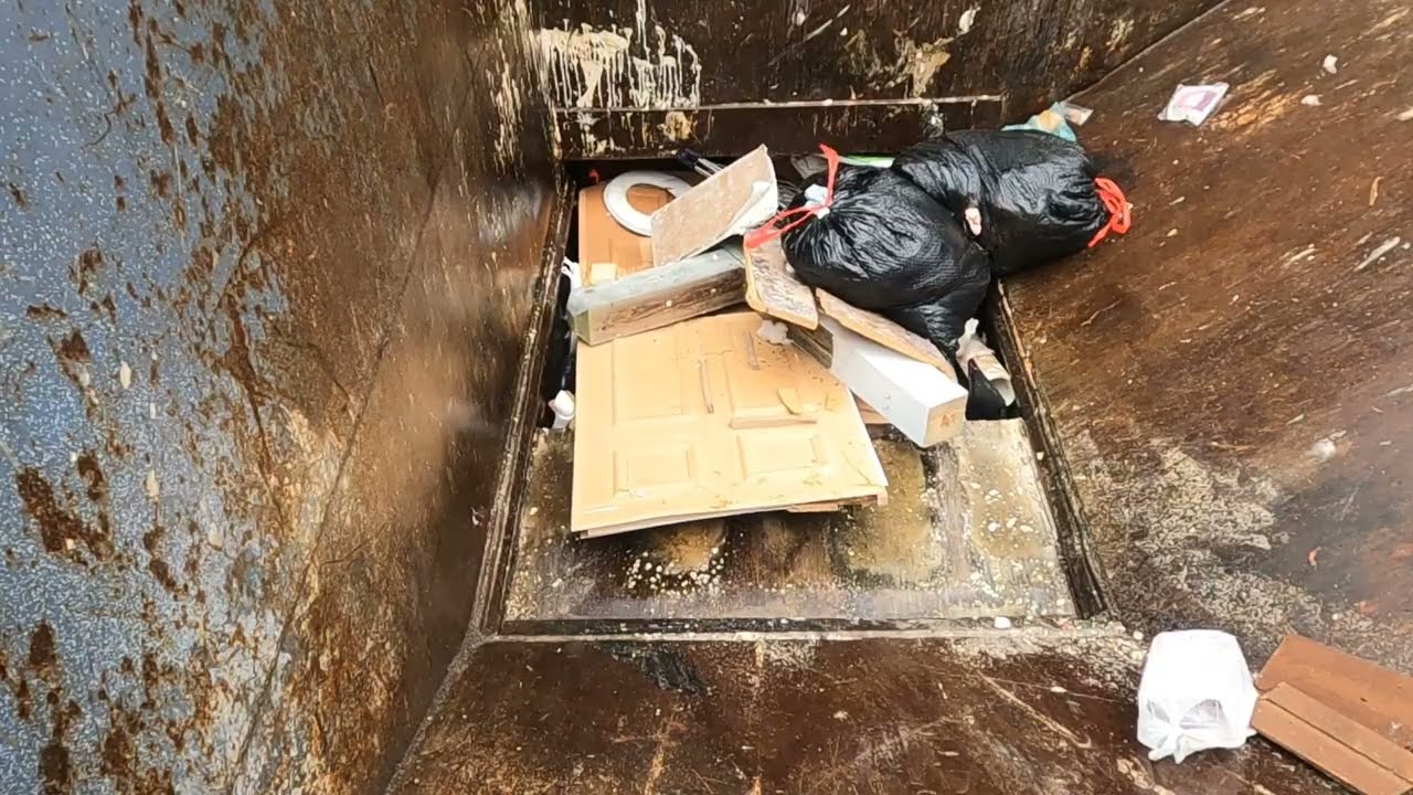 Compacting garbage on a rainy day 