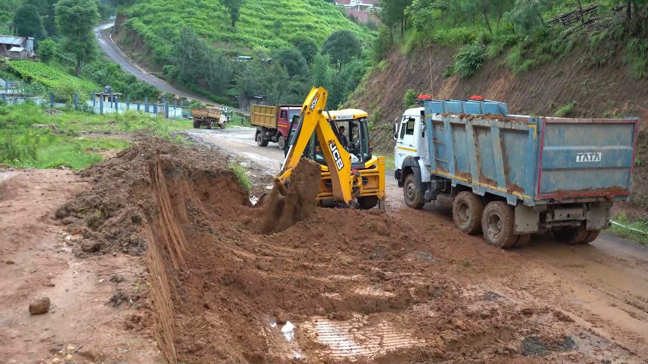 jcb loading soil in a tata 2825 dumper (Tipper)