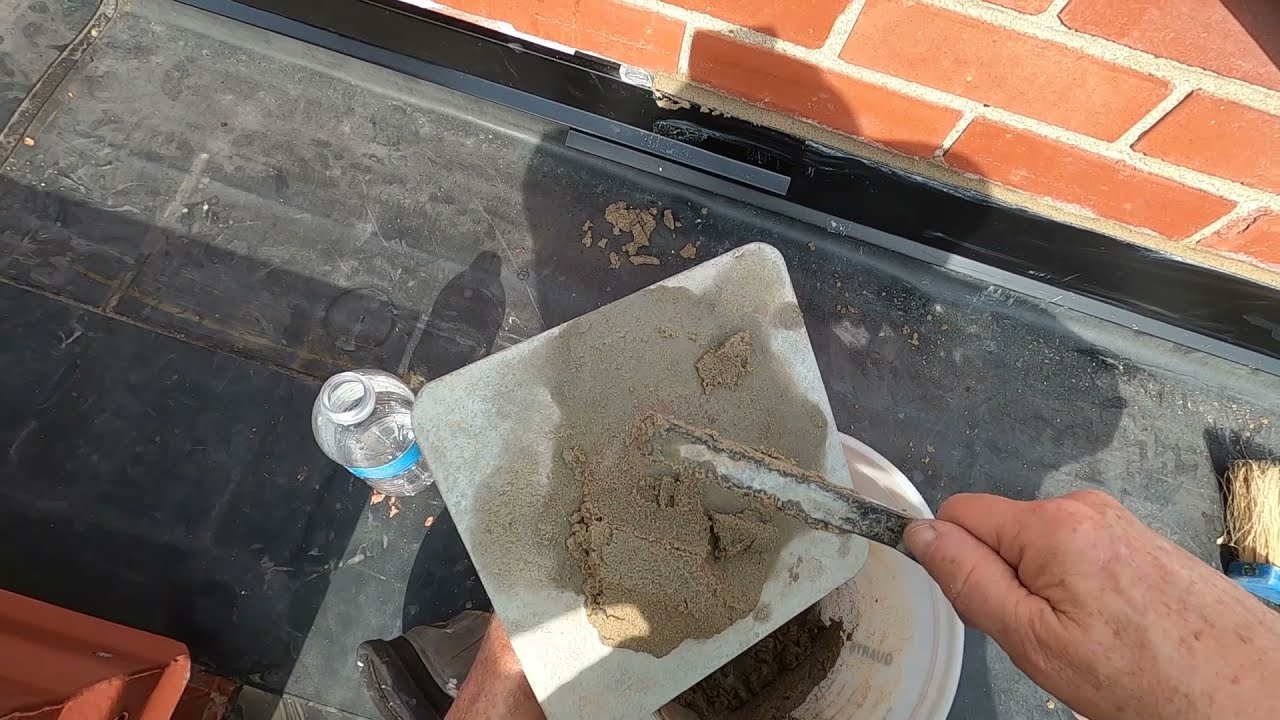 Flashing brick wall and basic tuck pointing to terminate flat roof