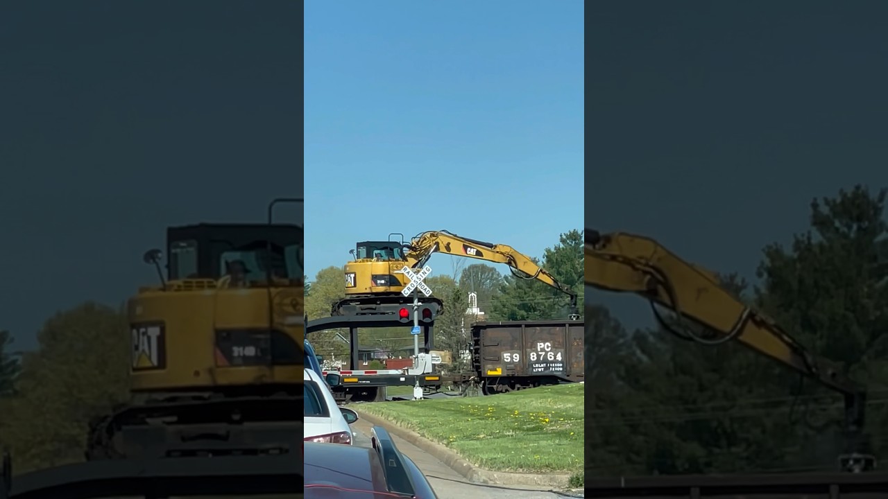 CAT Excavator Unloading Ties on a Moving Train