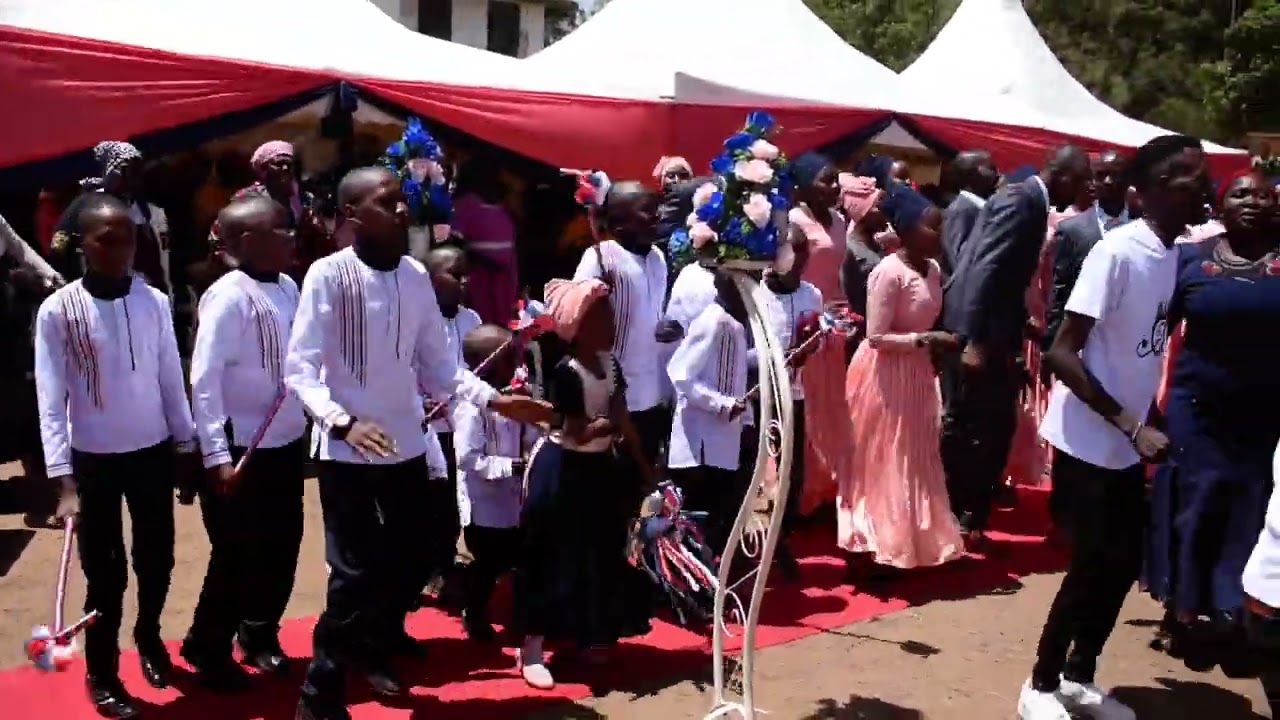 NITUKUINA RWIMBO KIGOOCO  DURING JOHN'S WEDDING.