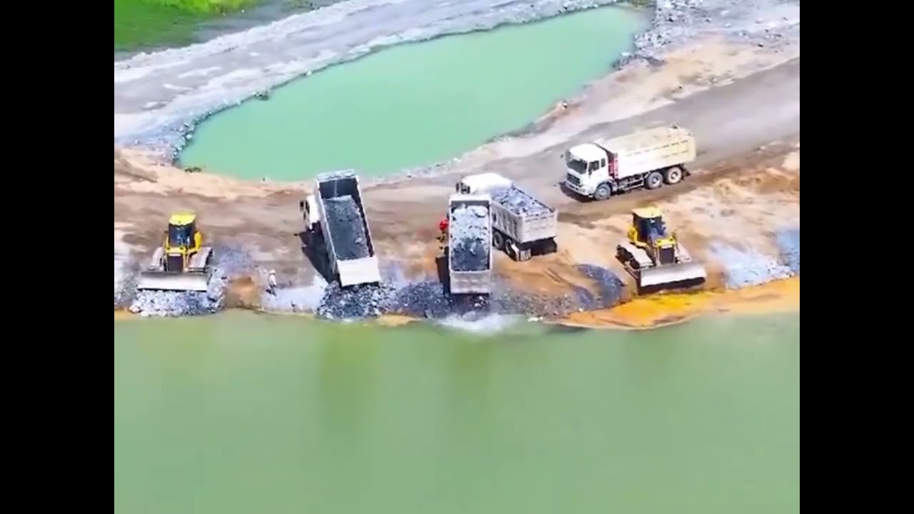 Bulldozer pushes rocks into deep water #roadconstruction #bulldozer
