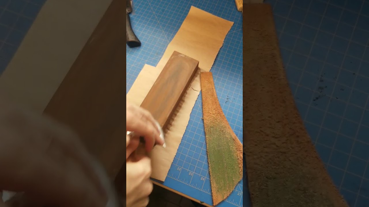 Sharpening a head knife on a whetstone.