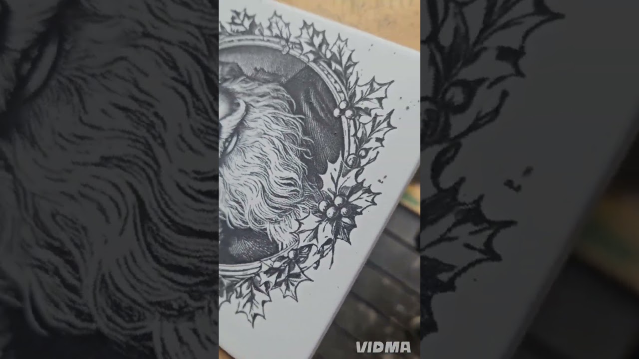 Laser engraving a white ceramic tile.