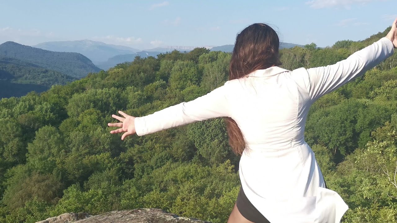 Jazz, tap dance in high heels in a white dress coat on the edge of the abyss