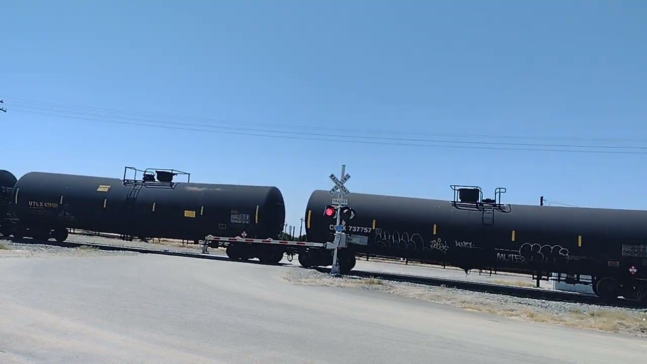 Long BNSF tanker train cruising towards downtown Bakersfield