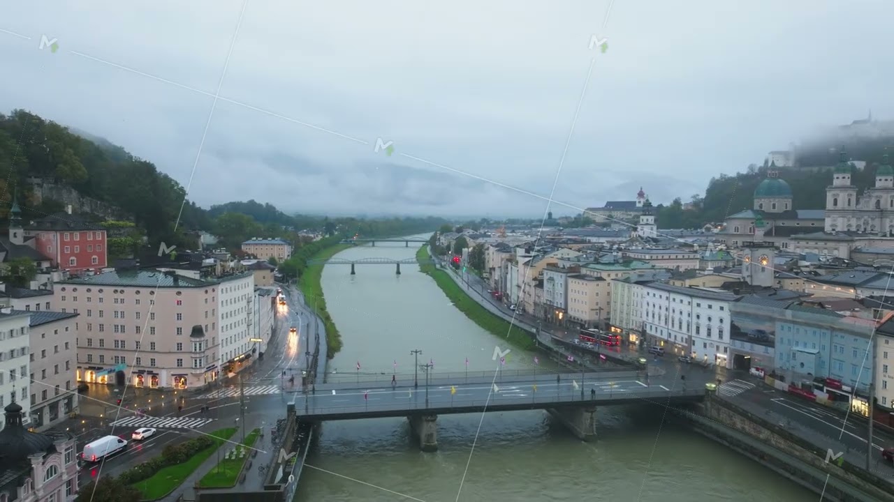 Aerial view of Salzburg city center with the Salzach River flowing through the urban landscape. The