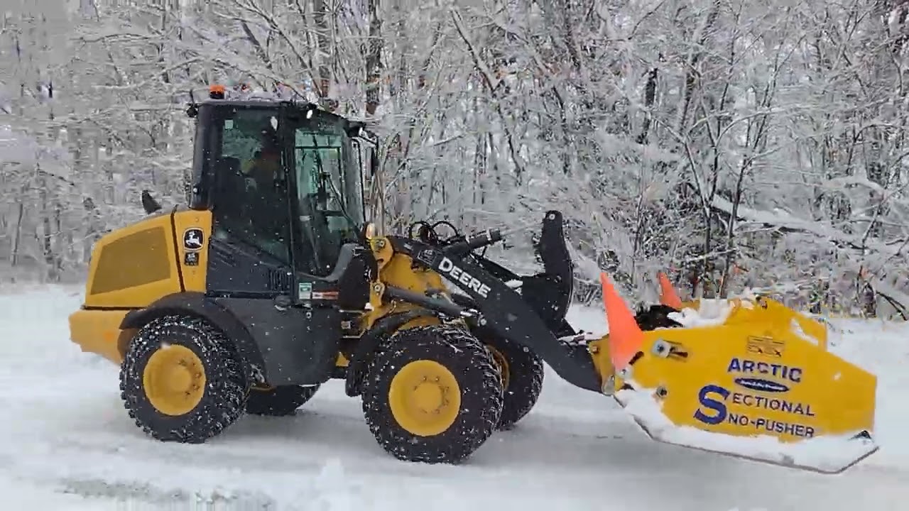 Chad in his John Deere 244 with arctic blade pushing snow like a BOSS