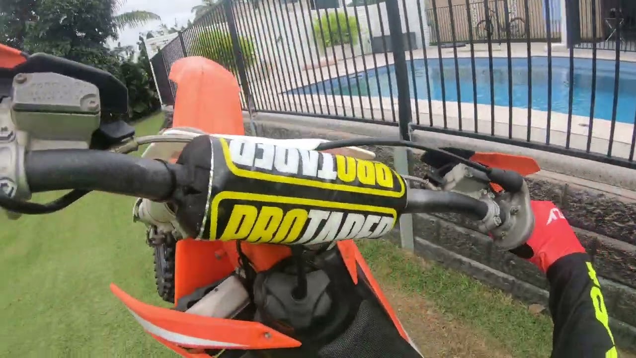 Mukking around top halve of back yard while the bottom halve is muddy 