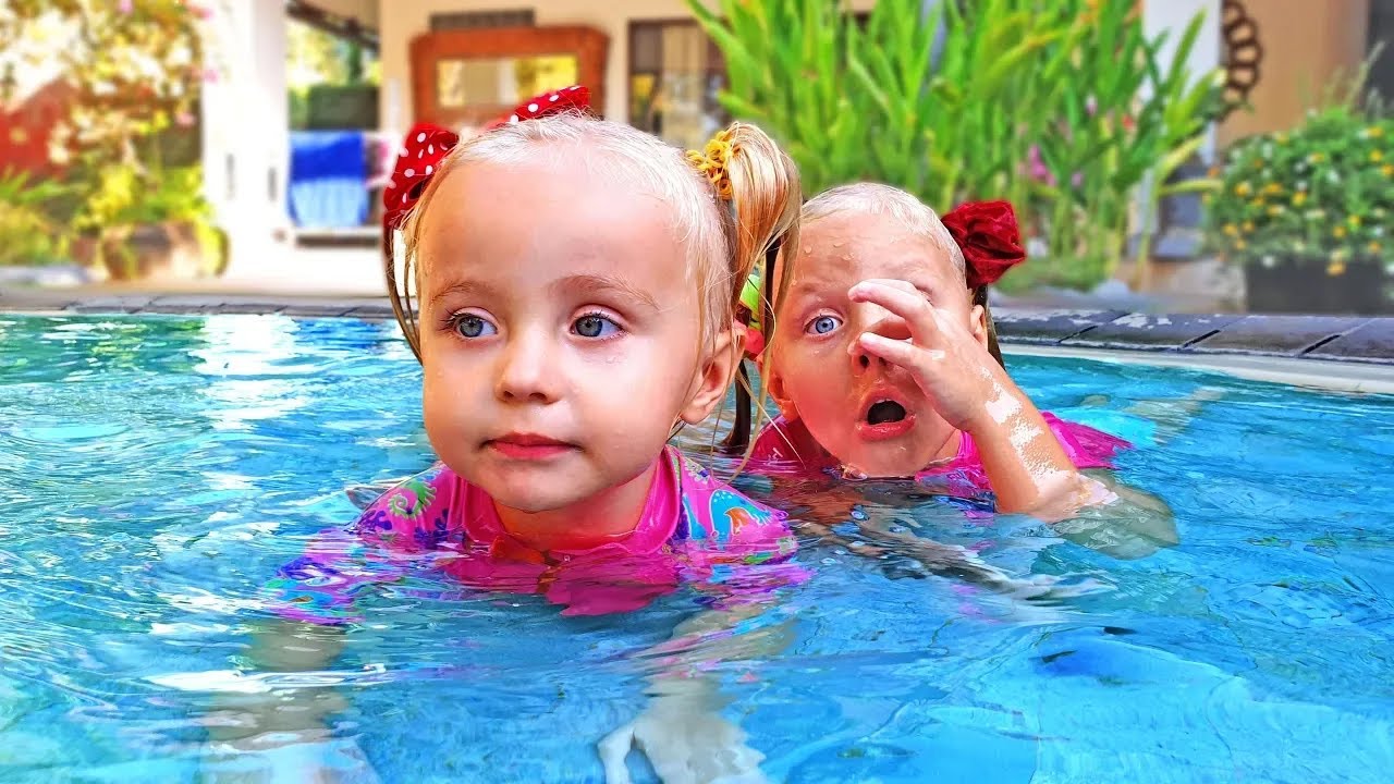 Kids play in Water Park and Giant swimming pool with Dinosaurs