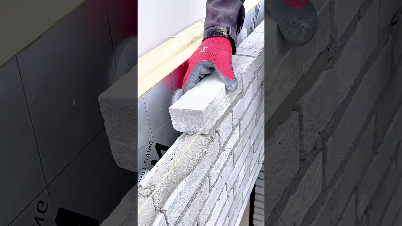 Detailed View of a Masonry Process Showing Brick Placement and Thin Mortar Jointing