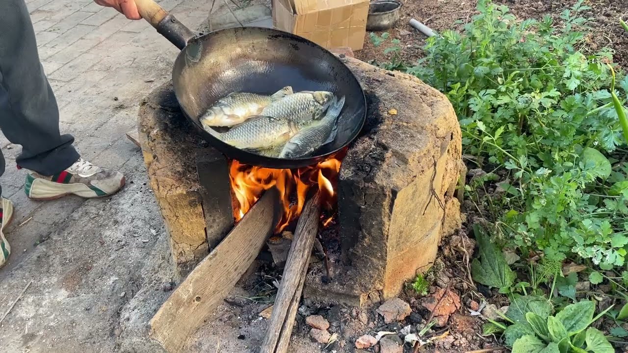 pan-fried wild crucian carp on a traditional clay stove#fish#cooking#