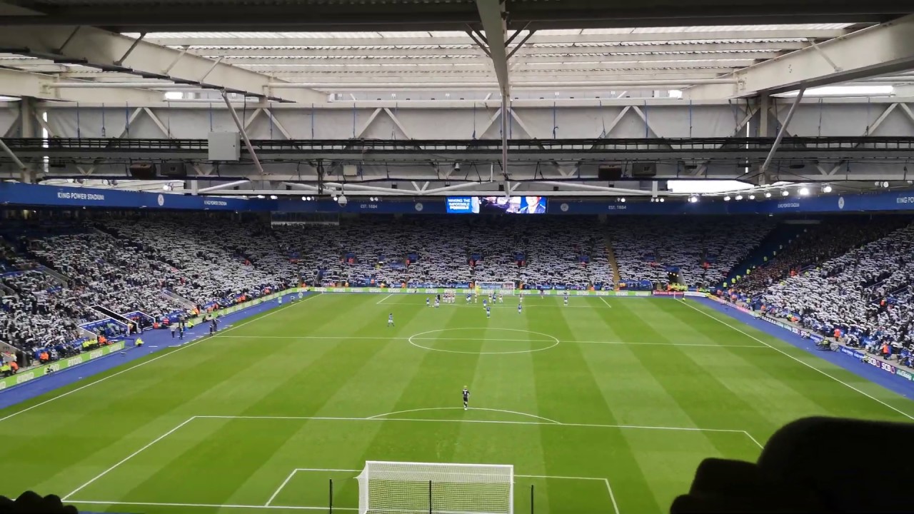 Leicester fans raise their scarves and sing 