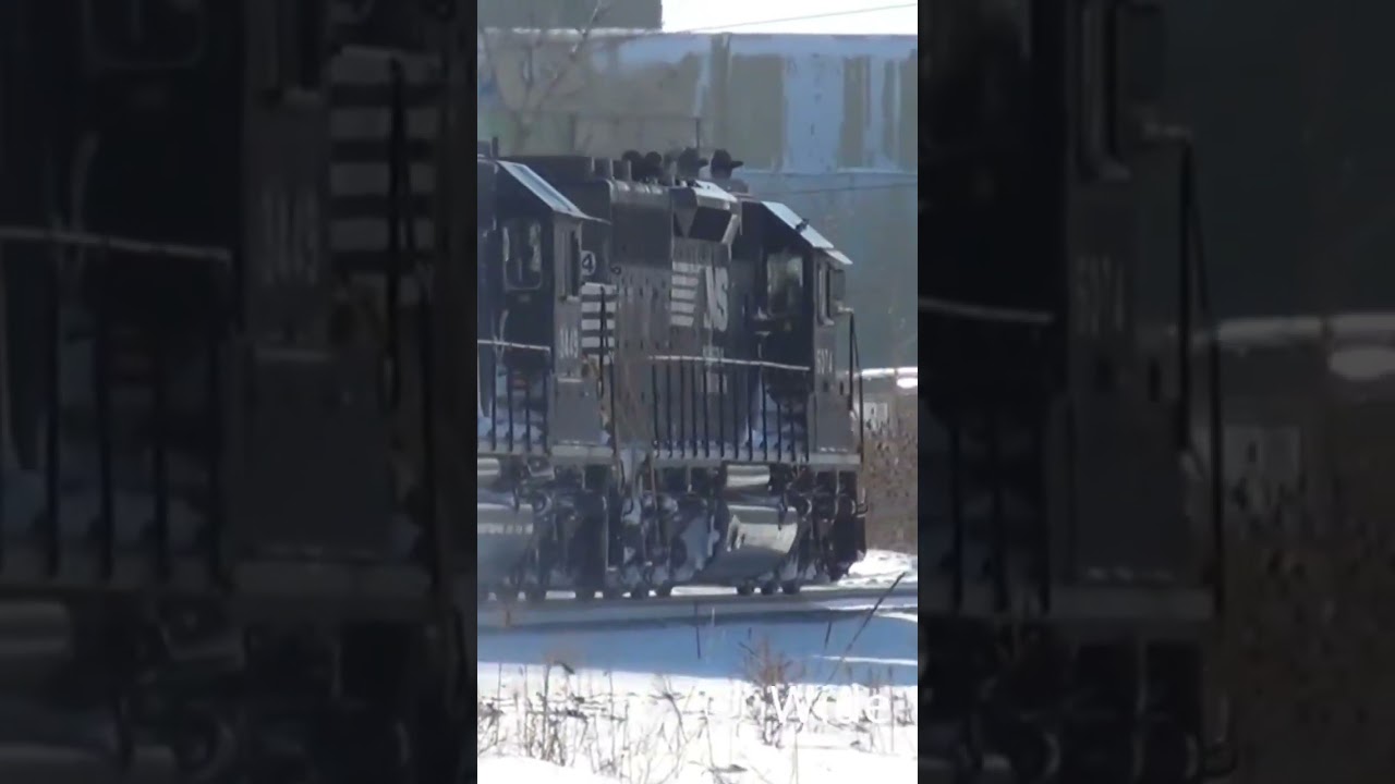 Pair of Norfolk, Southern SD40-2 engines Go through the snow.
