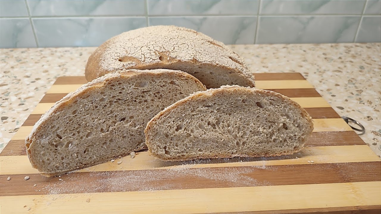 Two loves of bread, one made from regular flour and the other from whole wheat flour.