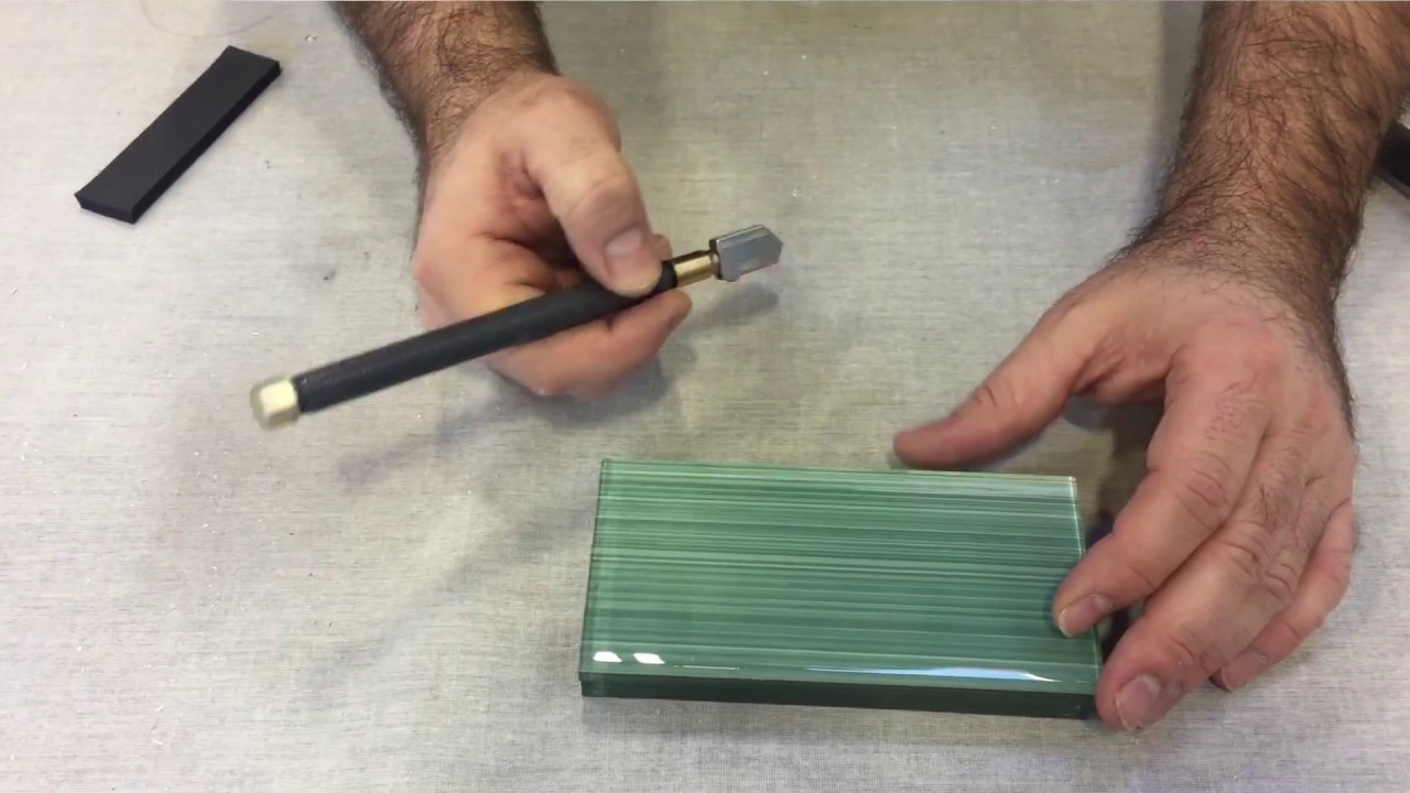Cutting glass tile using the score and snap method.