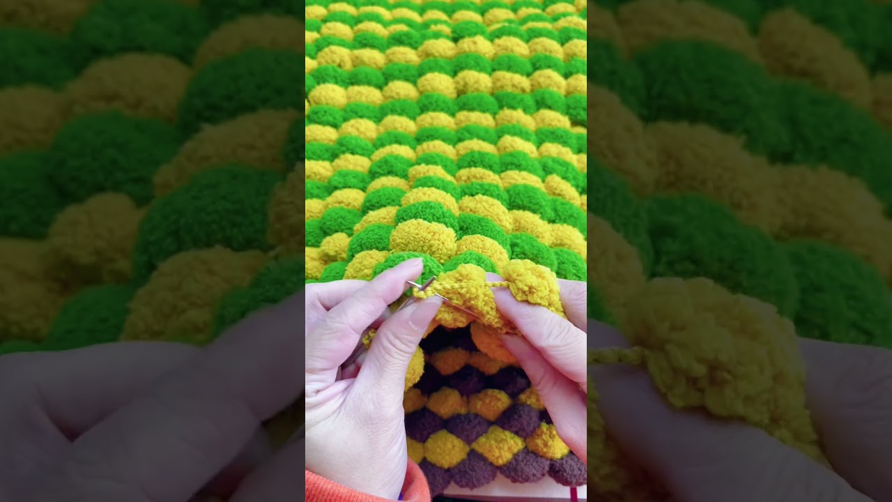 Knitting blankets with pom pom yarn