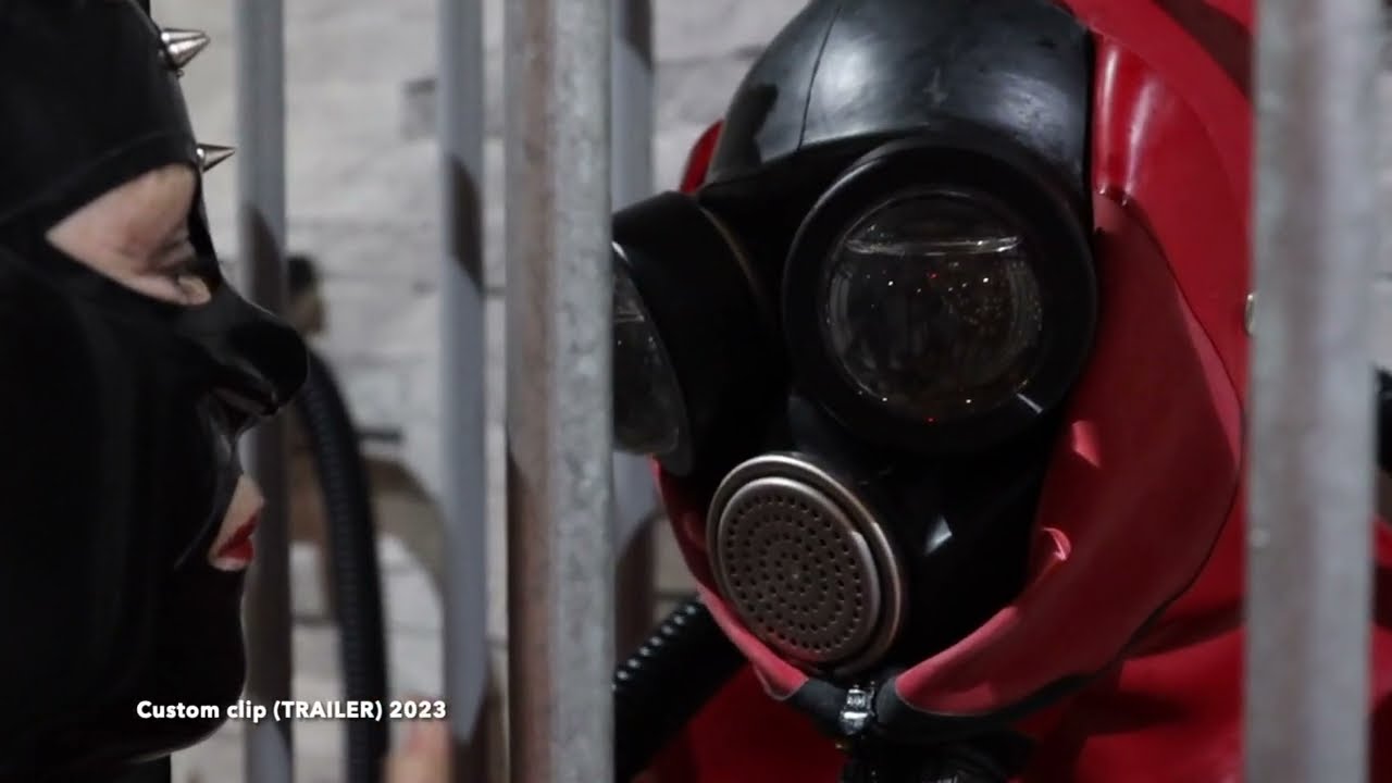 Mistress Cara (UK) with Rubber Drone in heavy rubber bondage sack, with with liquid dome lenses