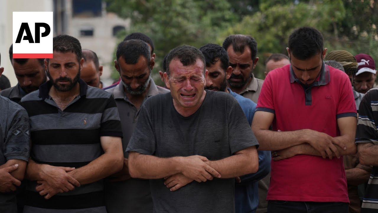 Palestinians at Gaza City morgue mourn victims of Israel strikes and shooting