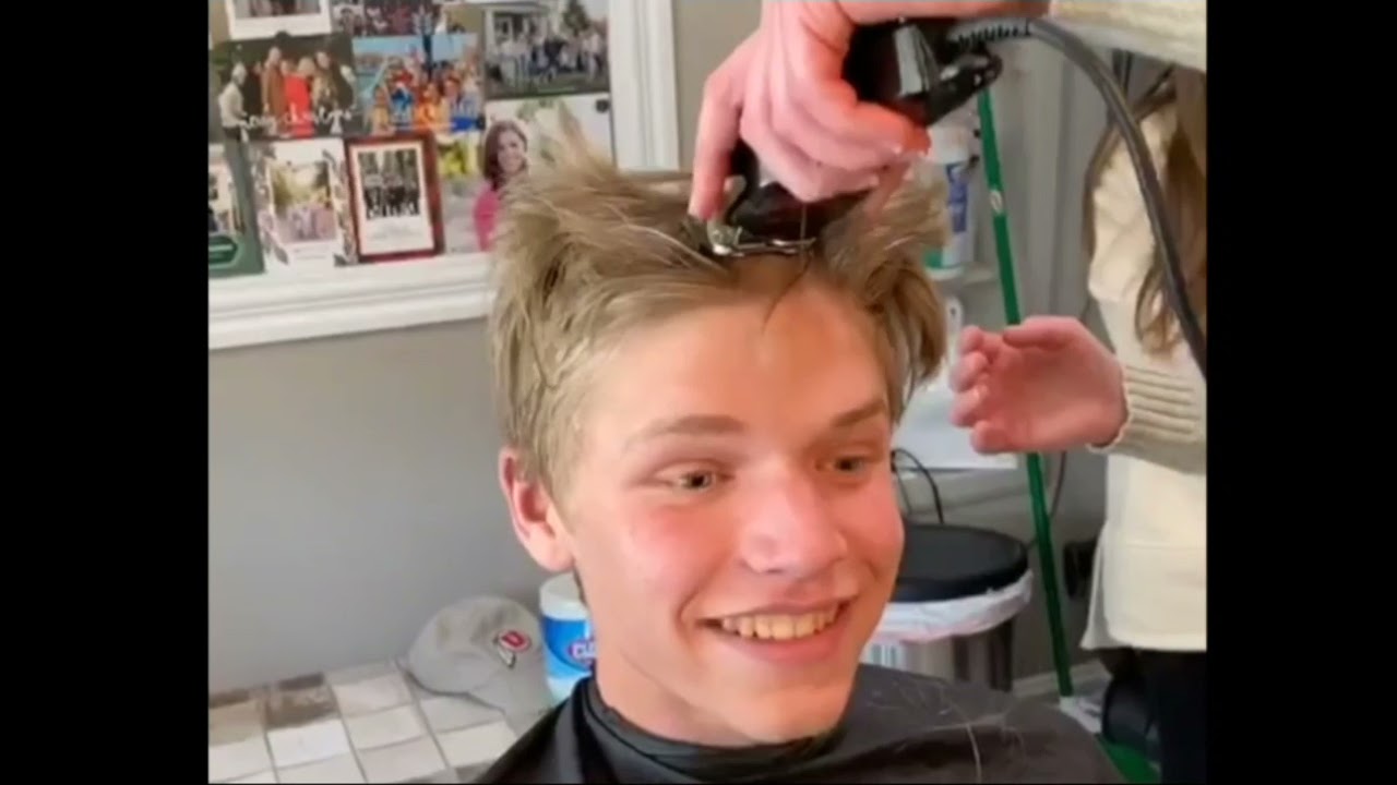 the boy is cutting all his hair