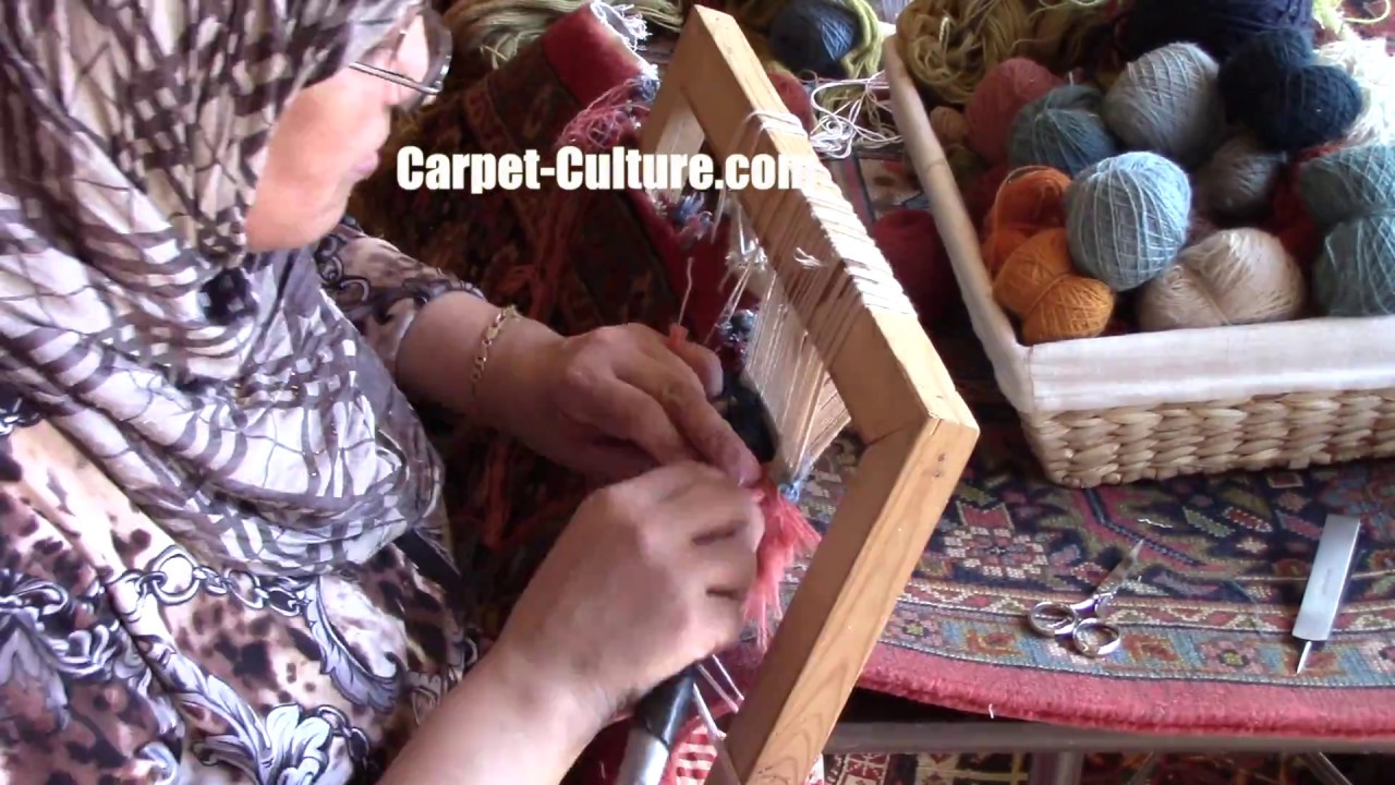Restoring the corner of an Antique Rug at Carpet Culture in Soho