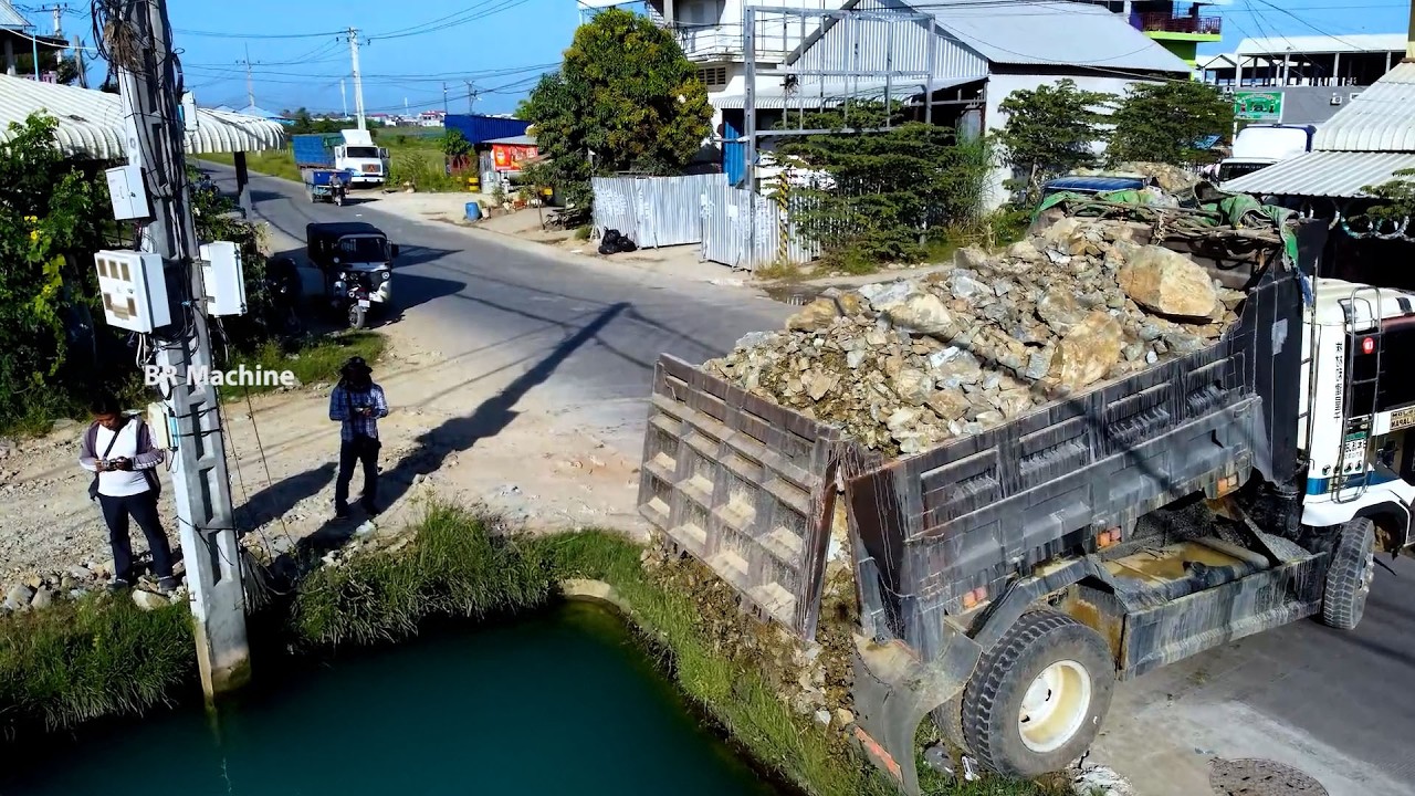 Amazing job DUMP TRUCK UNLOAD DTONE and bulldozer push stone filling flood area full project
