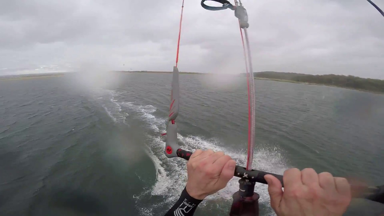 Weird hangtime at apex of kitesurfing jump with late downloop