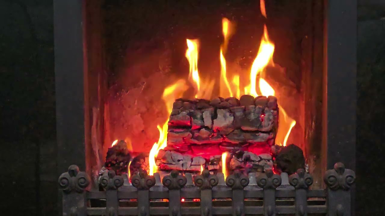 Glowing log embers, real open fire cosy night in Ireland