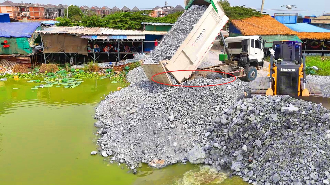 New Landfills !! Huge Gravel Operation Dump Trucks Filling Water Body Bulldozer Pushing Stone