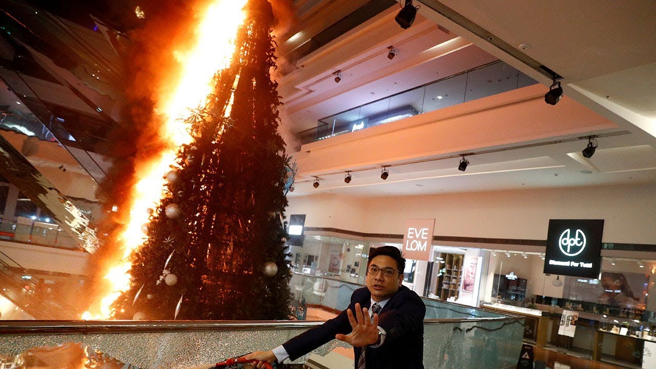 Hong Kong protesters throw molotov cocktails at police and set Christmas tree alight