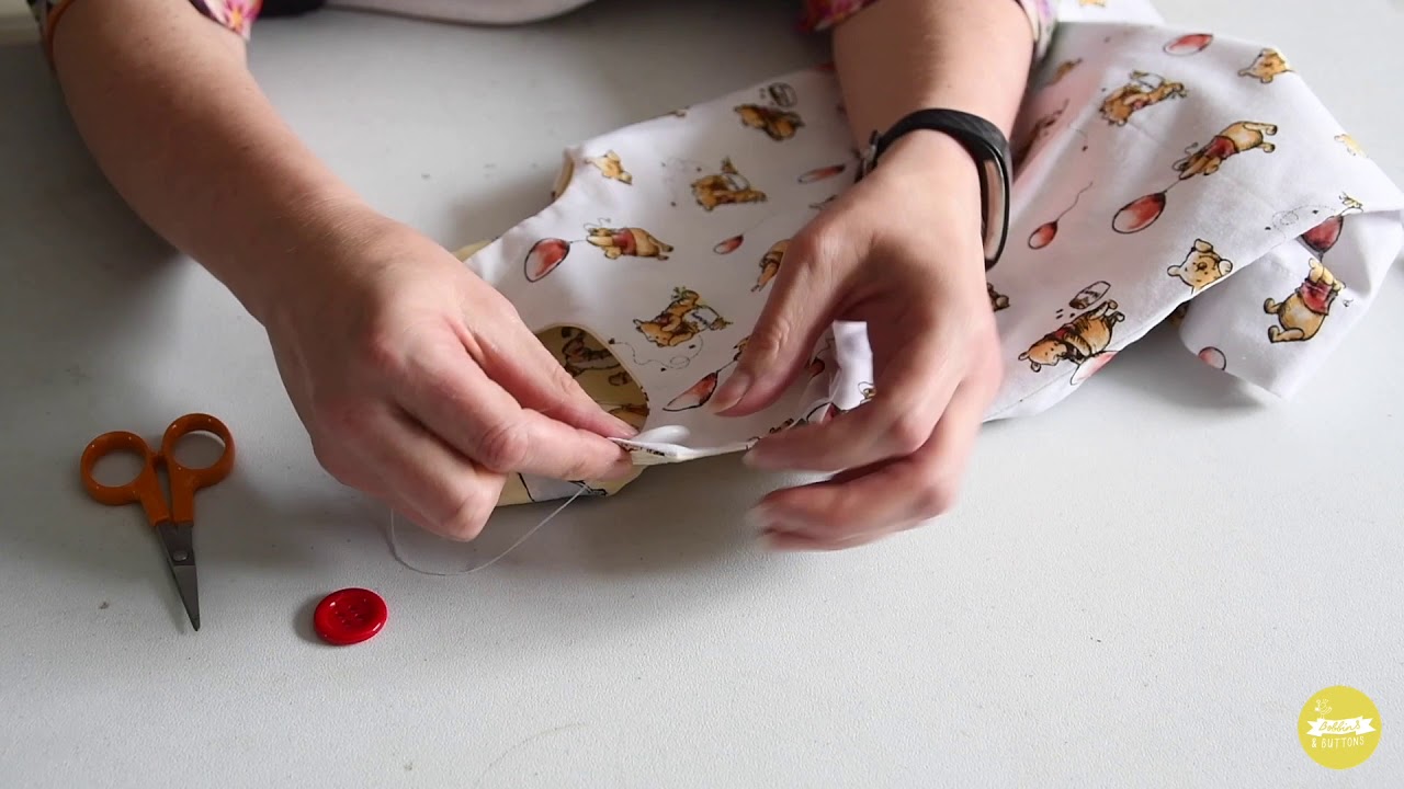 Sewing on a reversible button