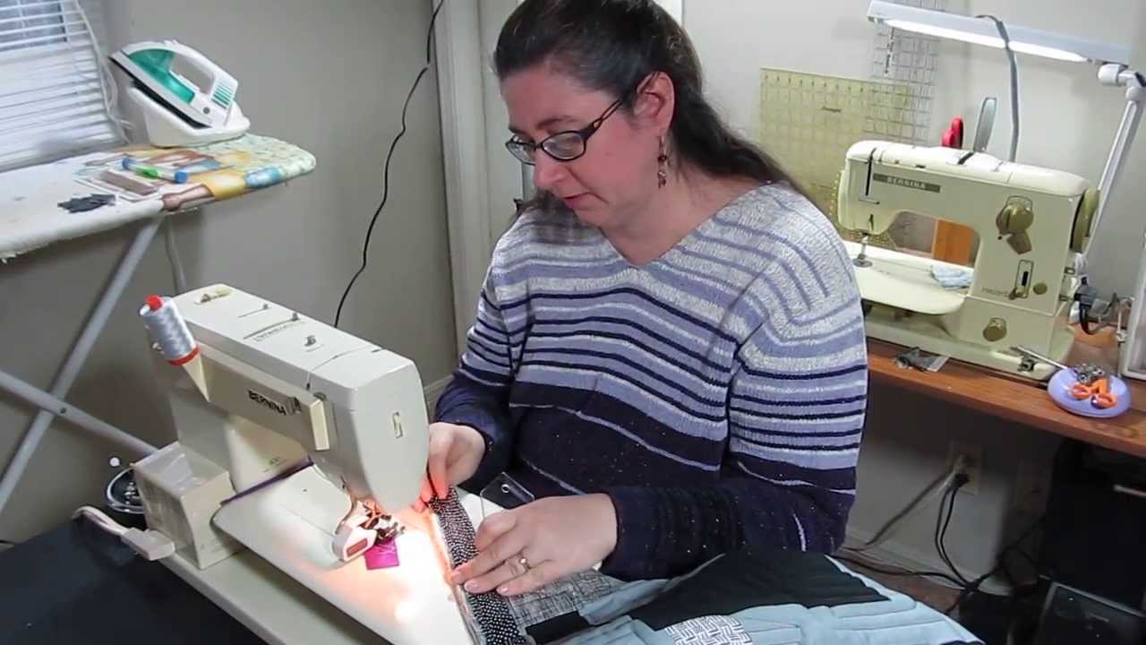 This is a quilting tutorial on how to use a binding miter tool for perfect mitered corners.