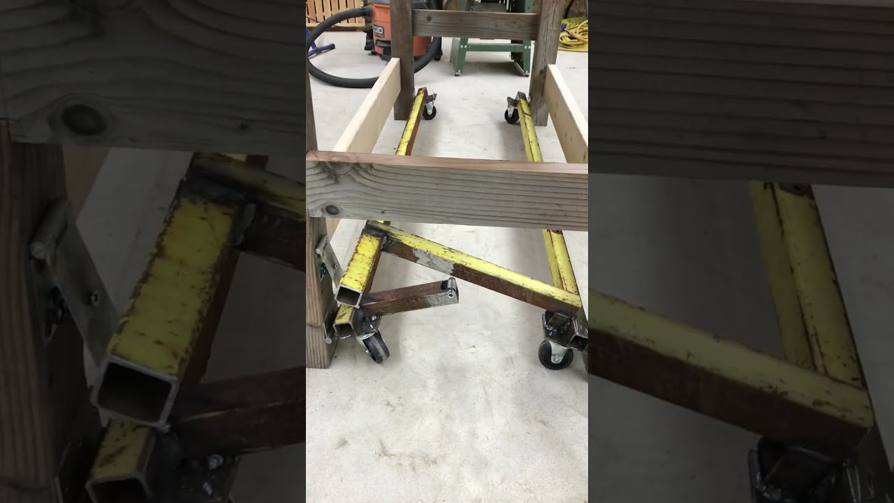Retractable caster system for a workbench