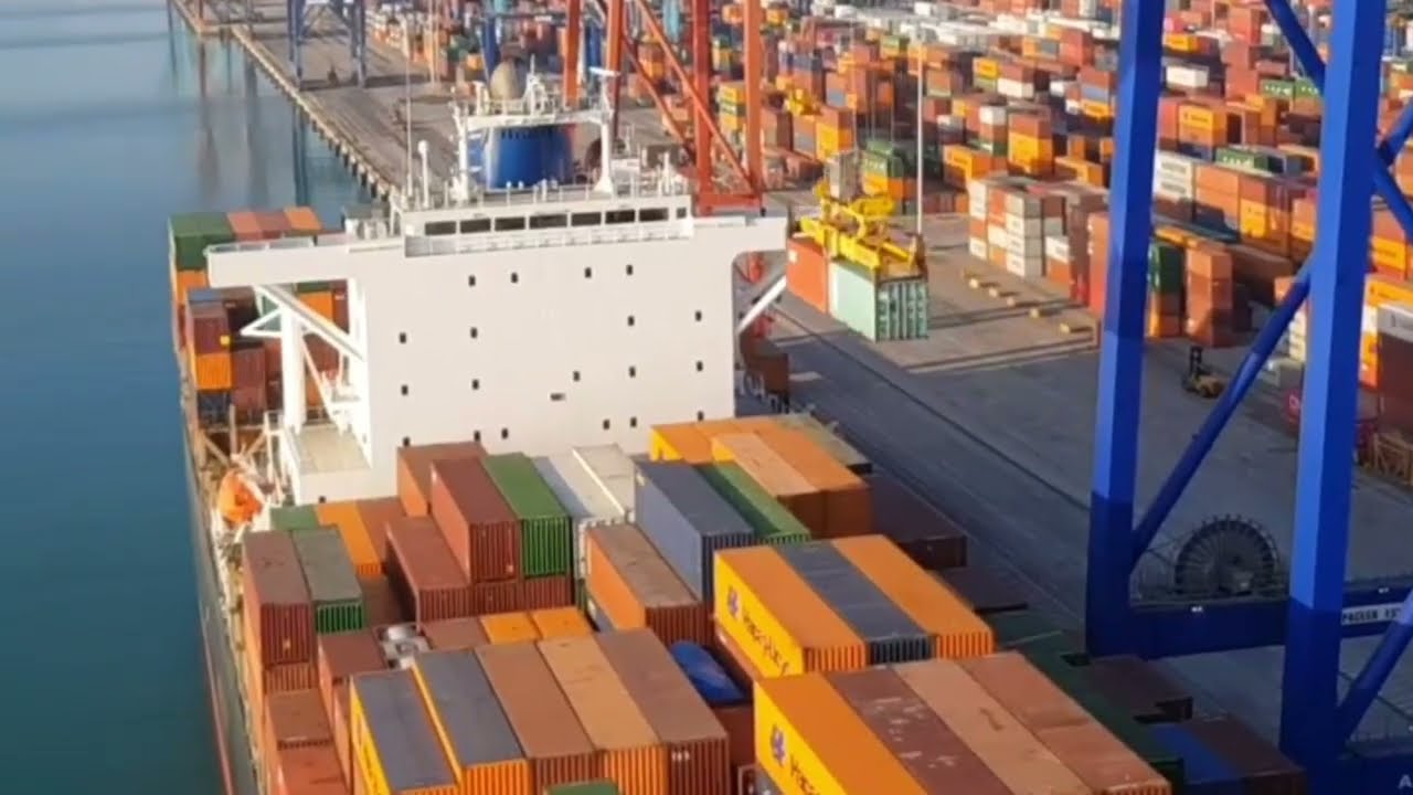 Loading of a cargo vessel with containers. A container ship. Seaport.