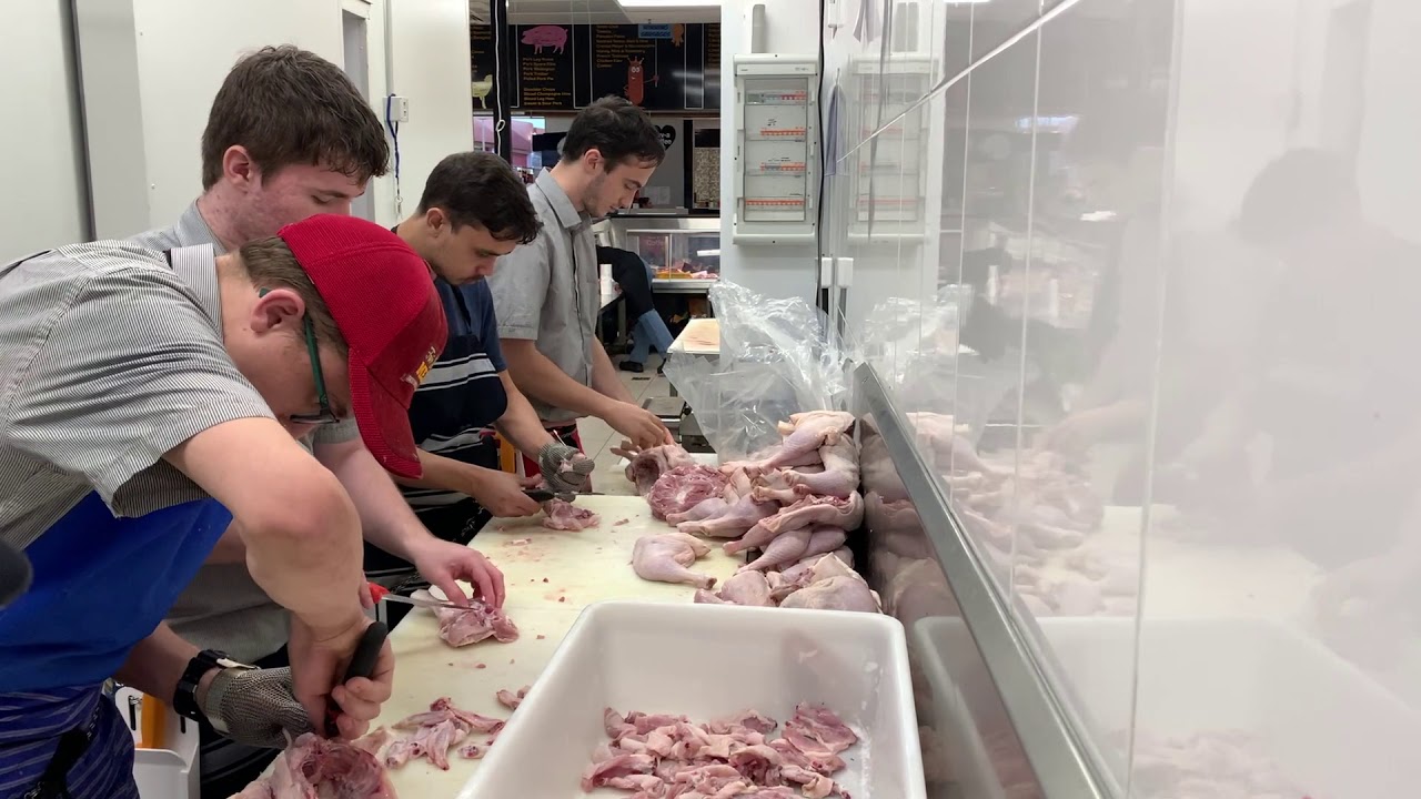 Butcher and apprentice at work,,,,,,