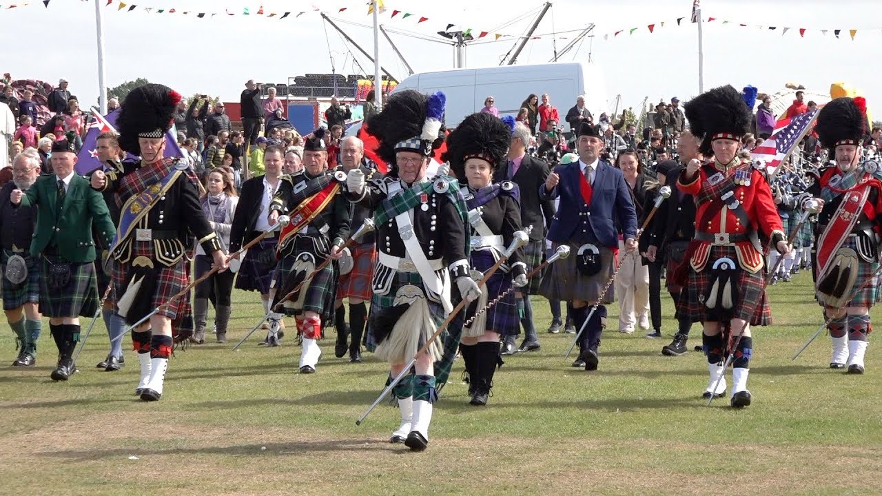 Massed Pipes & Drums parade through town to start the 2018 Nairn Royal Brackla Highland Games