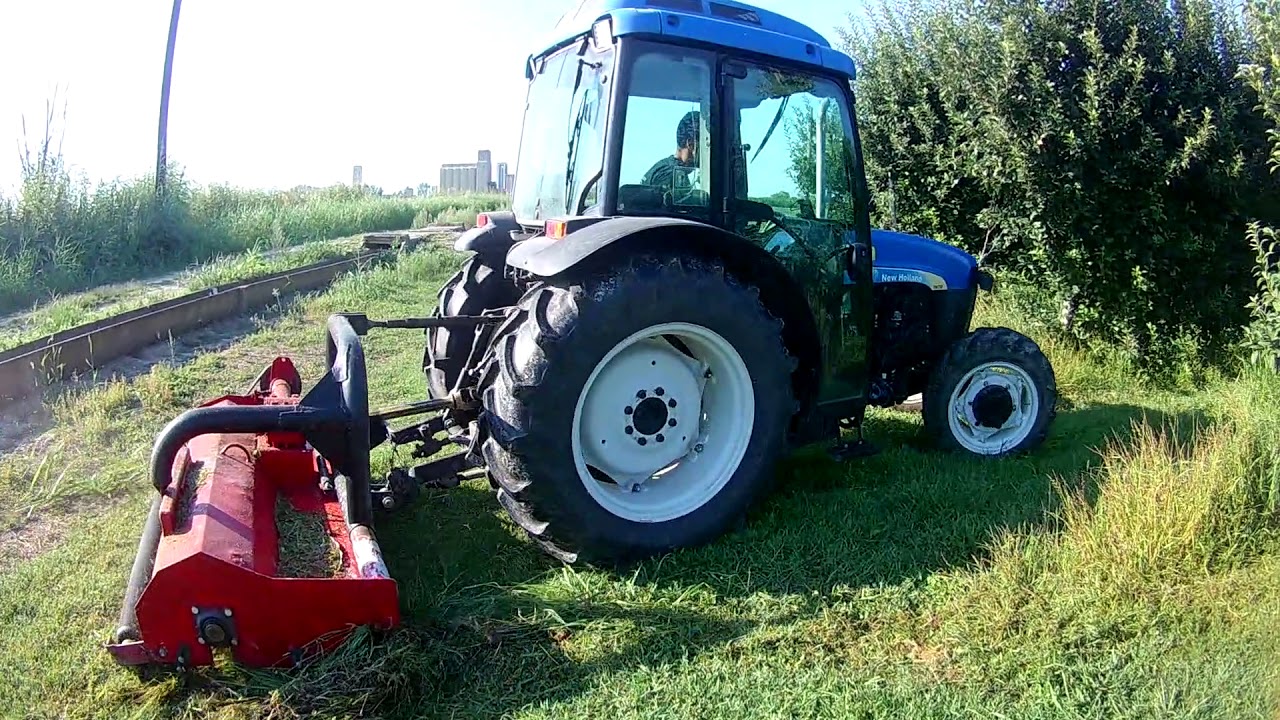 Mowing Apple orchard with New Holland TN75FA