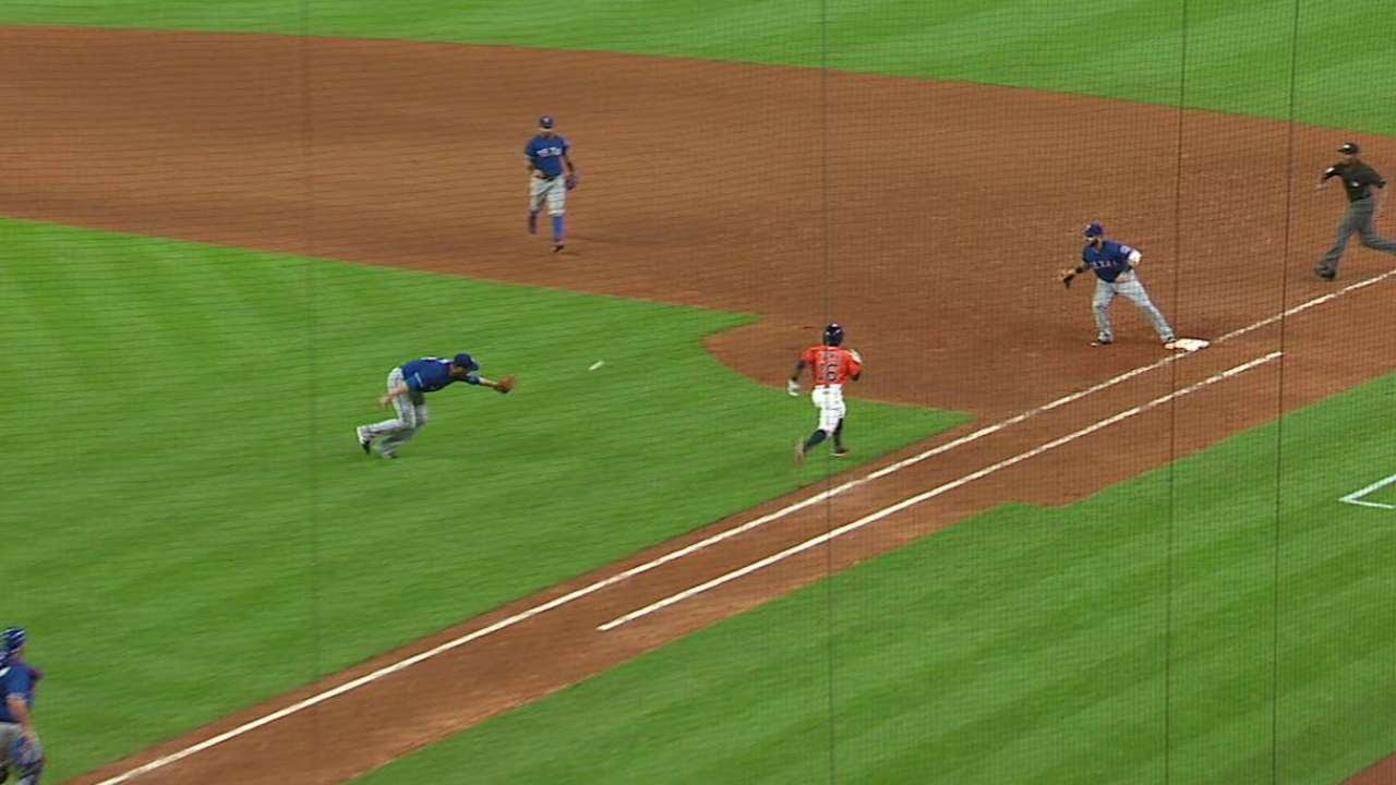 Lewis flips the ball with his glove to first