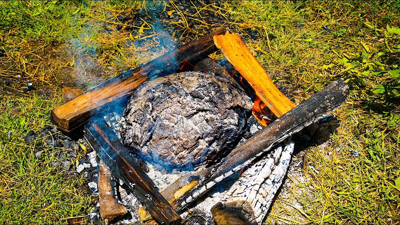 The chicken is grilled inside the mud layer. Cooking alone in the forest
