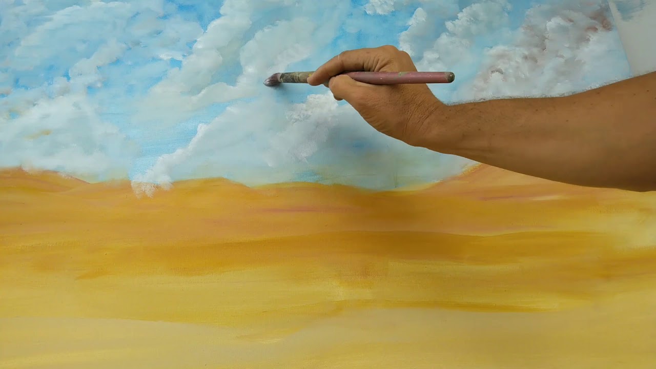 رسم شجرة في الصحراء مع غيوم كثيفه....