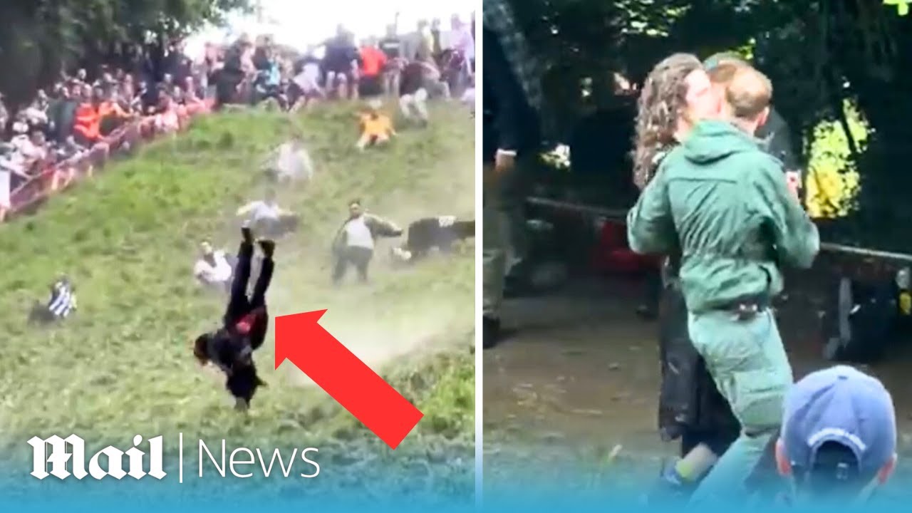 Moment man somersaults down cheese-rolling hill