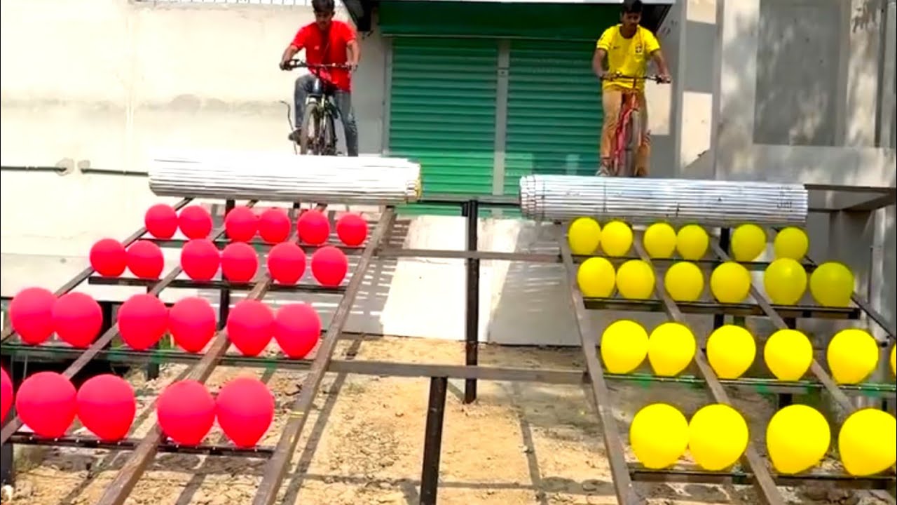 Competing to the end in the funny balloon bursting game of two youngsters