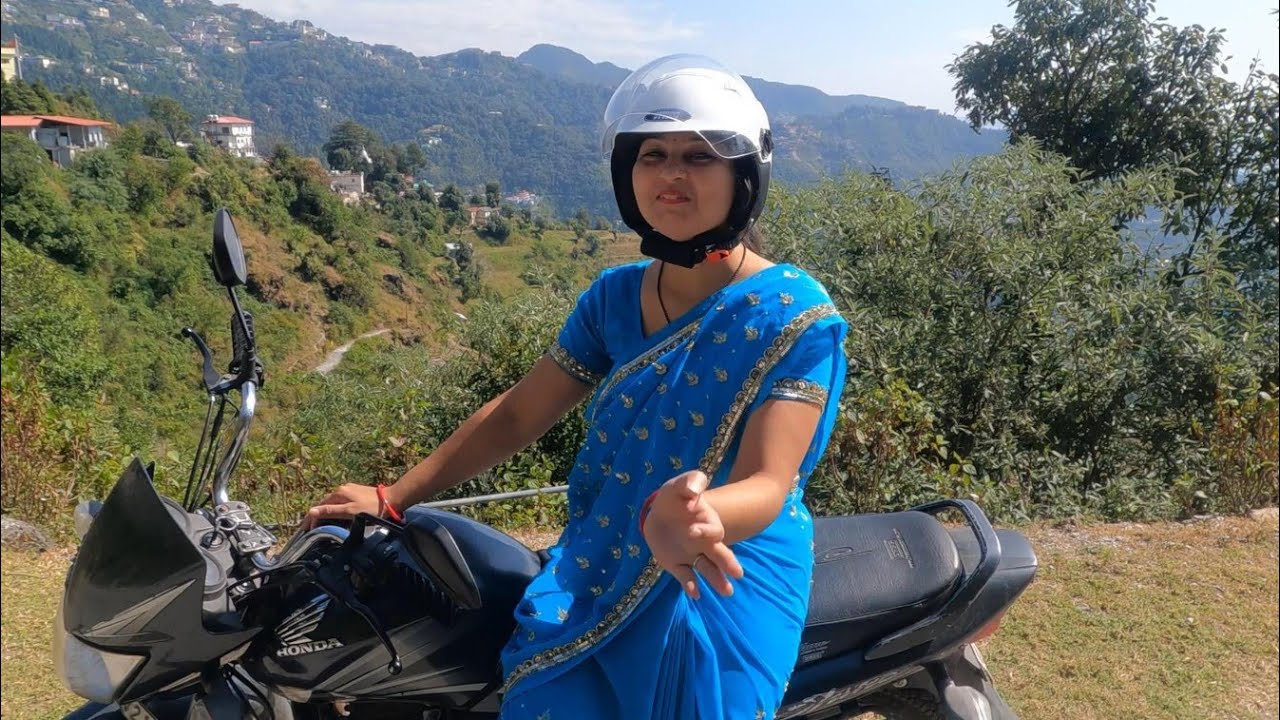 Female bike riding in blue saree
