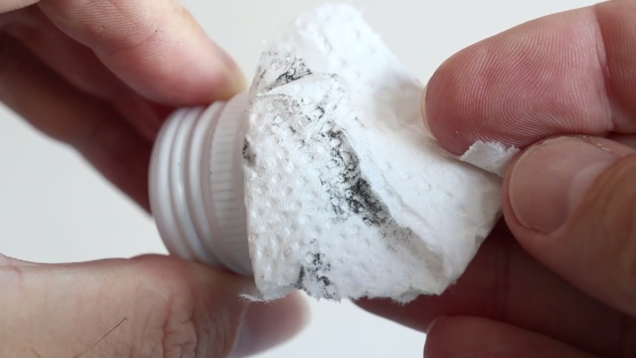 Black on the inside of a strong booze (strong, drinkable alcohol) bottle cap