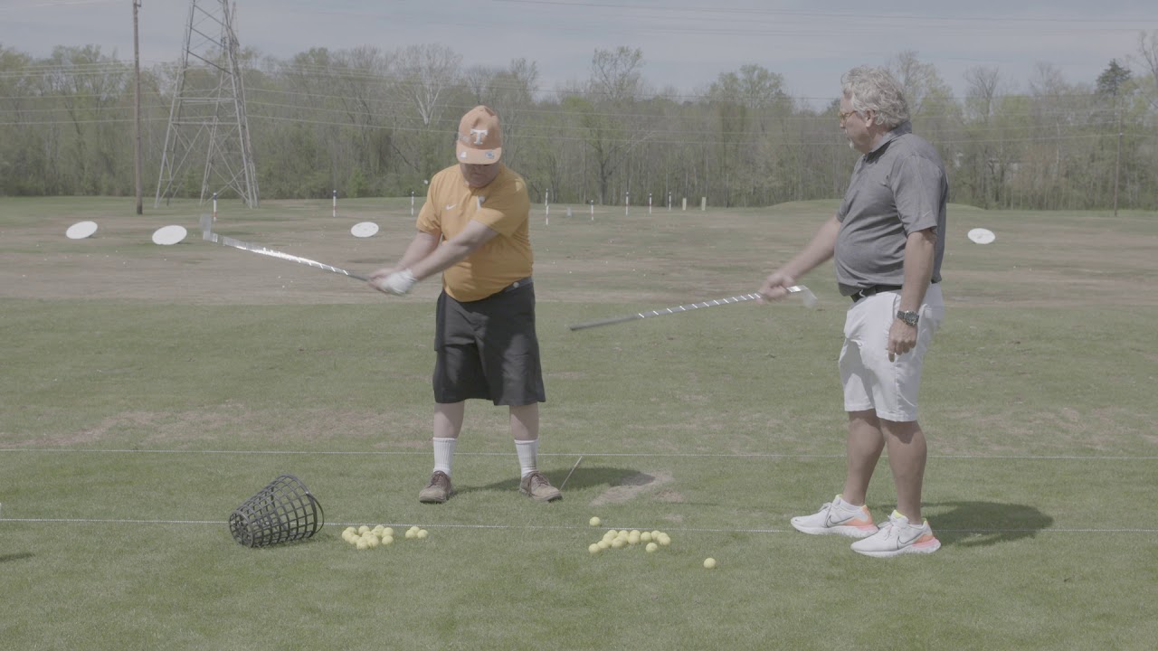Kip Henley shows Mike Mixson the proper motor in the golf swing