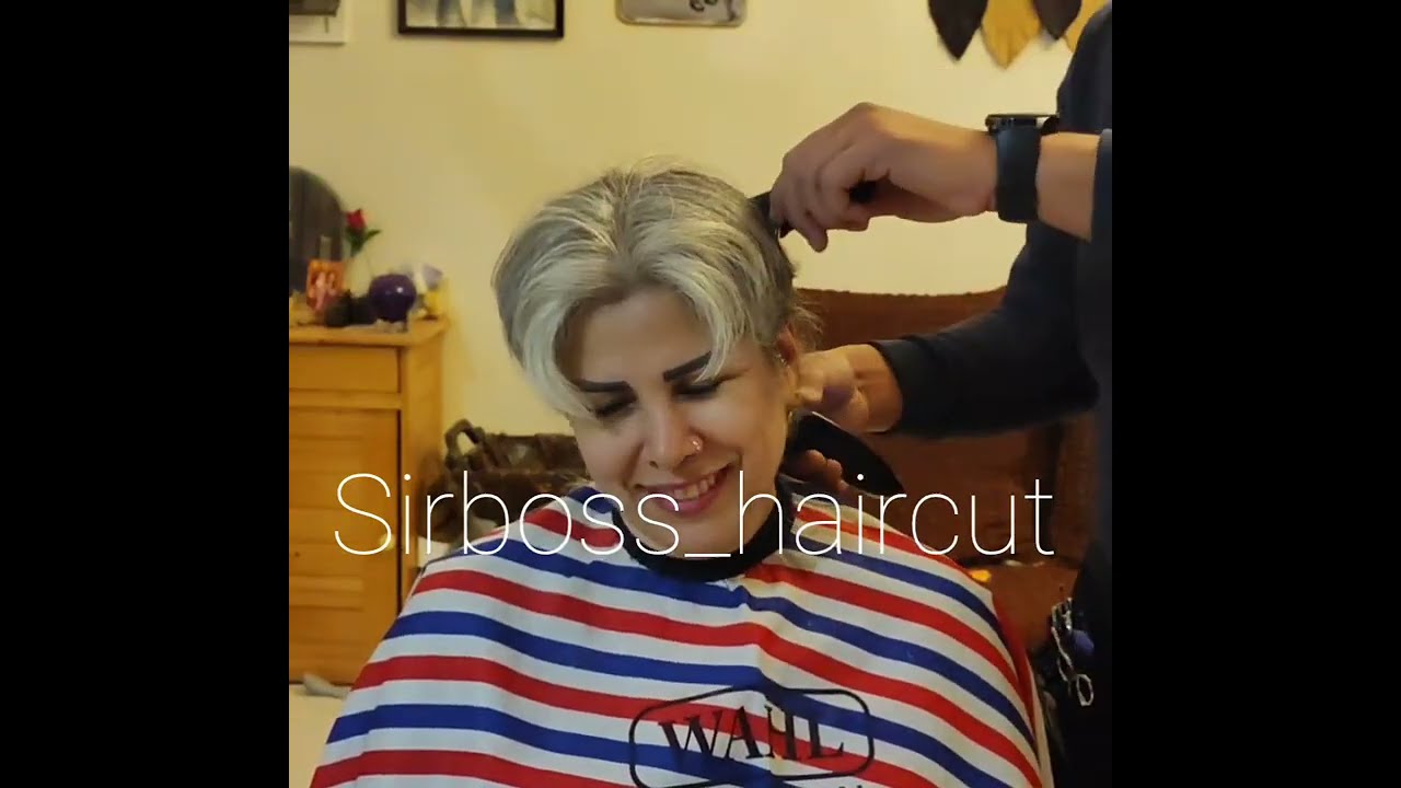 woman headshave in barbershop by man