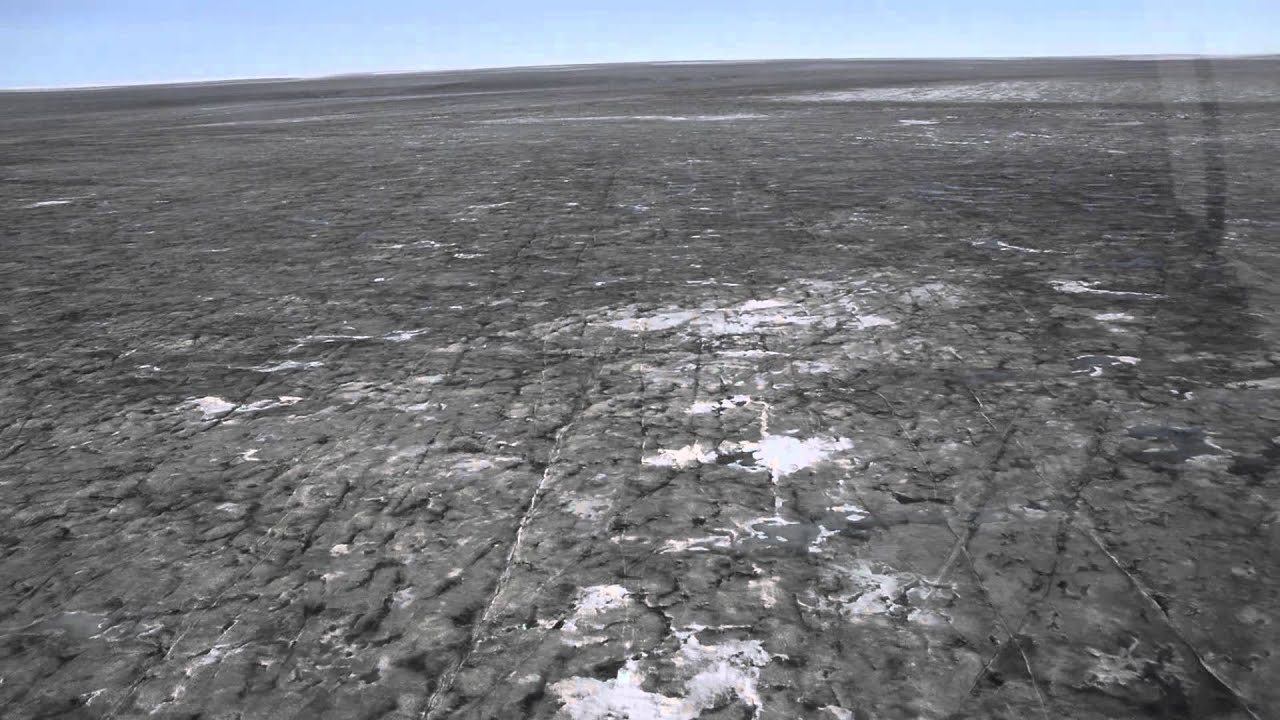 flying over dark Greenland ice