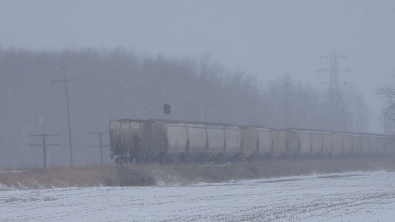 2/22/26 grain trains in the snow sb csx 157 5501 nb lsrc 6356 1776 willard road and clio bikepath
