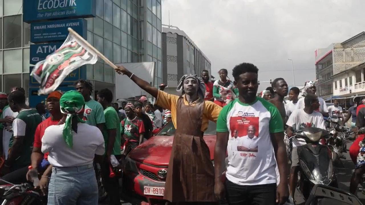 Supporters of Ghana's opposition party celebrate in the streets of Accra after ruling party concedes