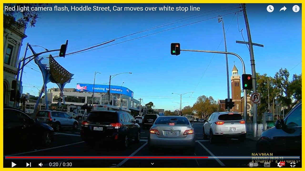 Red light camera flash, Hoddle Street, Car moves over white stop line